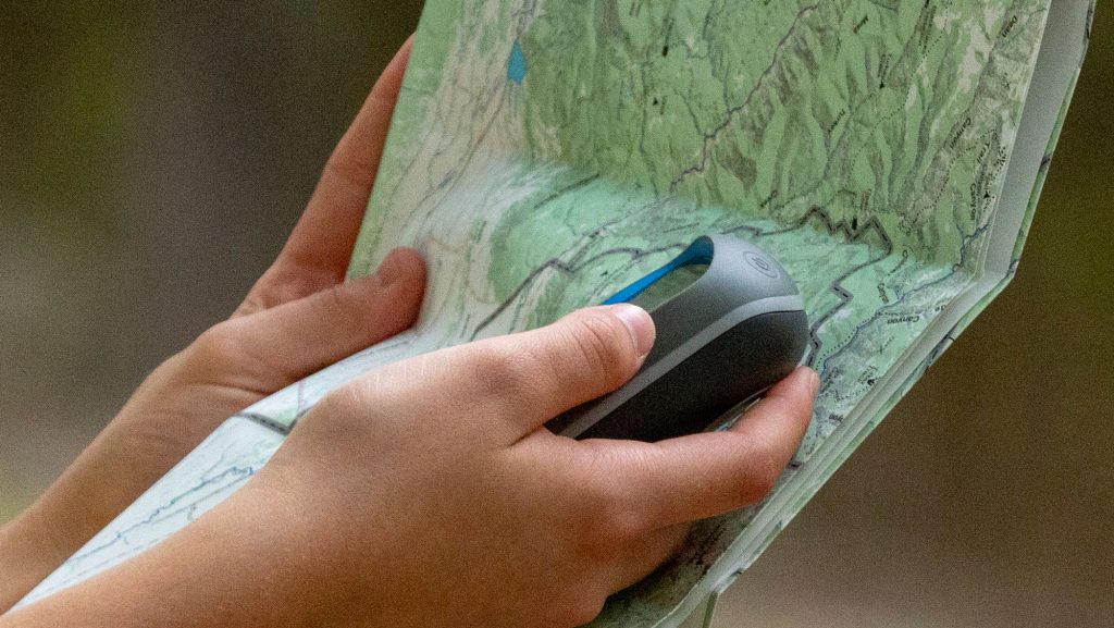 Hand with GPS and map
